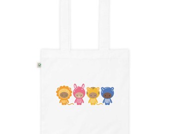 May include: A white tote bag with four cartoon animals wearing costumes. The animals are a lion, a bunny, a tiger, and a hippo. The lion is wearing a yellow costume, the bunny is wearing a pink costume, the tiger is wearing an orange costume, and the hippo is wearing a blue costume.