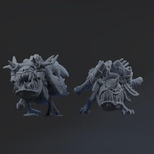 Op de afbeelding: Twee grijze miniatuurfiguren met fantasiethema van een wezen met een grote mond, hoorns en pantser. De figuren zijn dynamisch geposeerd, wat beweging suggereert. Details zijn scherpe tanden en getextureerde oppervlakken.