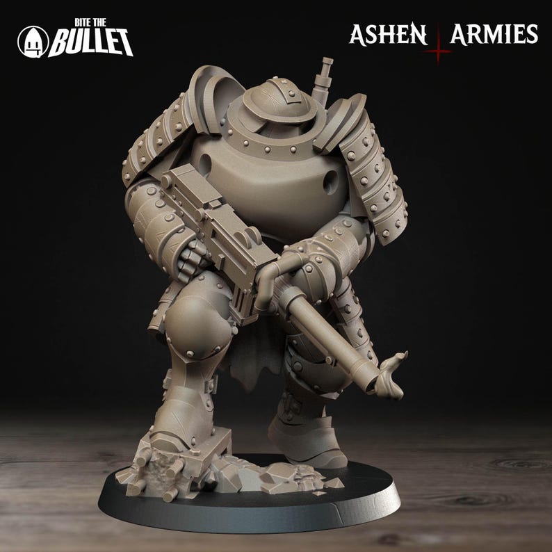 Puede incluir: Figura en miniatura gris detallada de un soldado fuertemente blindado, arrodillado y sosteniendo un rifle grande. La figura tiene un casco y cuerpo redondeados, con remaches y blindaje visibles. La base es gris oscuro, con las etiquetas "Ashen Armies" y "Bite the Bullet."