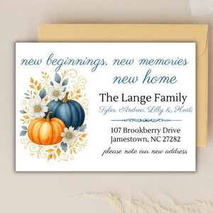 May include: A white card with a watercolor design of pumpkins and flowers, with the text "new beginnings, new memories, new home." The Lange Family's name and new address are also printed on the card. The card is inside a gold envelope.