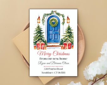 May include: A Christmas card with a watercolor illustration of a blue front door with a wreath, flanked by two Christmas trees and presents. The text reads "Merry Christmas from our new home Ryan and Brianna Olson 330 Patriot Road Southbury, CT 06488".