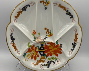 May include: White divided serving dish with a gold rim and floral design. The dish features a central floral arrangement with orange, yellow, and blue flowers. Decorative scrollwork in orange, navy, and pink accents the rim.