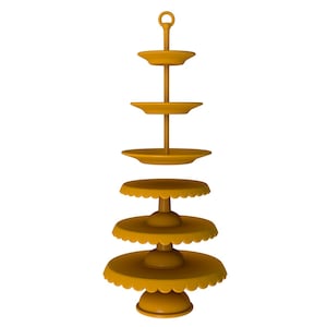 May include: A gold-coloured tiered serving stand with five levels. The stand is made of metal and has a decorative scalloped edge on each level.