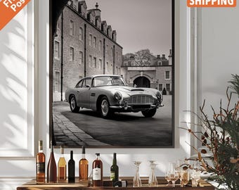 May include: A black and white photograph of a classic silver car parked in front of a brick building. The car is a vintage Aston Martin.