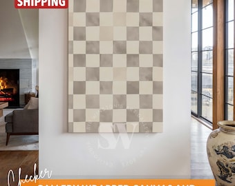 May include: A large, rectangular canvas print with a checkerboard pattern in shades of gray and white. The canvas is displayed on a white wall in a modern home interior.