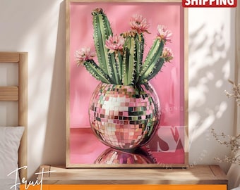May include: Framed wall art featuring a cactus with pink flowers in a disco ball vase against a pink background. The artwork is in a wooden frame and is labeled "Fruit FRAMED AND POSTER WALL ART".