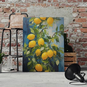 An original oil painting canvas print of vibrant lemons against a blue background. Available in multiple seizes with free shipping. Pictured leaning on a wall