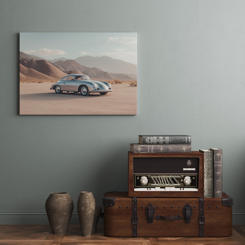 An original color car poster featuring the iconic Porsche 356 in silver in a desert. Available in  multiple sizes with free shipping. Pictured above a radio. (frame not included)