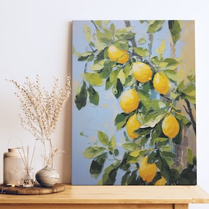 An oil painting canvas print of yellow lemons and leaves against a blue background. Available in multiple sizes with free shipping. Pictured leaning on a shelf