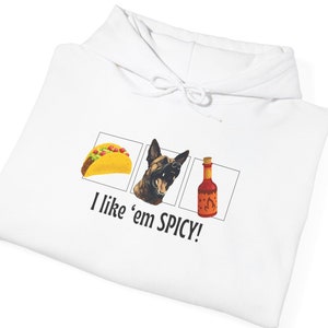 May include: White hoodie with a graphic of a taco, a dog, and a bottle of hot sauce. The text "I like 'em SPICY!" is printed below the graphic.
