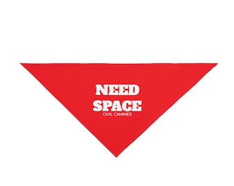 May include: A bright red triangular bandana with the white text "NEED SPACE" and "CIVIL CANINES" printed on it. The bandana is likely for a dog and is designed to communicate a need for personal space.