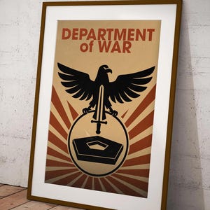 May include: Framed poster with a brown border, featuring the text "DEPARTMENT of WAR" in red. A black eagle with a sword is centered above a circular emblem with a building outline and radiating lines in a tan and red colour scheme.