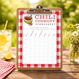 May include: A clipboard holding a Chili Cookoff Scoresheet with a red and white checkered border. The sheet features a bowl of chili graphic, instructions, and a grid for scoring appearance, taste, consistency, aroma, and spice for multiple entries.