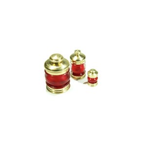 May include: Three decorative jars with red bodies and gold-coloured lids. The jars are of varying sizes, with the largest jar on the left and the smallest on the right. The jars have a classic, ornate design.