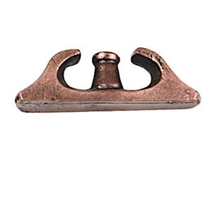 May include: A copper-toned metal cleat featuring a flat rectangular base with two curved arms extending upward on each side and a central vertical post. The hardware has a smooth, metallic finish with visible dark shading in the recessed areas.