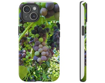 May include: A phone case featuring a vibrant image of grapes on the vine. The design showcases clusters of green, purple, and pink grapes amidst green leaves. The case has a black camera cutout and a white border.