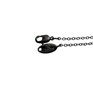 May include: A black metal necklace chain featuring a lobster claw clasp and an oval-shaped metal tag. Both the clasp and the tag are embossed with a small orb logo design. The chain consists of small, uniform circular links in a dark finish.