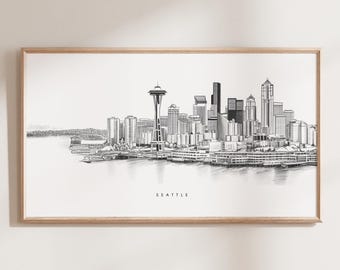 May include: A black and white line drawing of the Seattle skyline, featuring the Space Needle and other buildings. The drawing is framed in a light wood frame and the word "Seattle" is printed below the image.