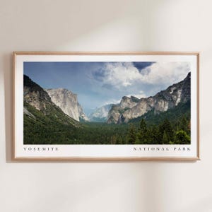 May include: A panoramic view of Yosemite National Park, showcasing towering granite cliffs, lush green forests, and a valley with a river winding through it. The sky is partly cloudy, with a hint of blue peeking through the clouds.