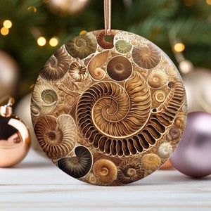 May include: A round, brown and gold Christmas ornament with a swirling pattern of fossilized ammonites. The ornament is made of ceramic and has a glossy finish.