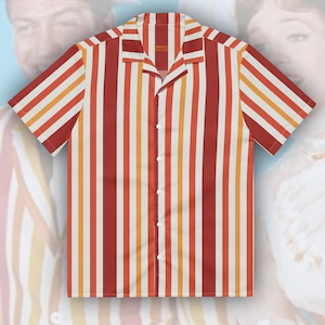 May include: A short-sleeve button-down shirt featuring a vertical striped pattern in shades of red, orange, and white. The garment has a notched collar, a straight hem, and five white buttons running down the center front placket.