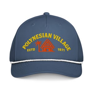 May include: A blue cap with a white rope detail and a curved brim. The cap features the text "POLYNESIAN VILLAGE" in yellow arched lettering, with an orange illustration of a hut and palm tree. The text "ESTD 1971" is also included.