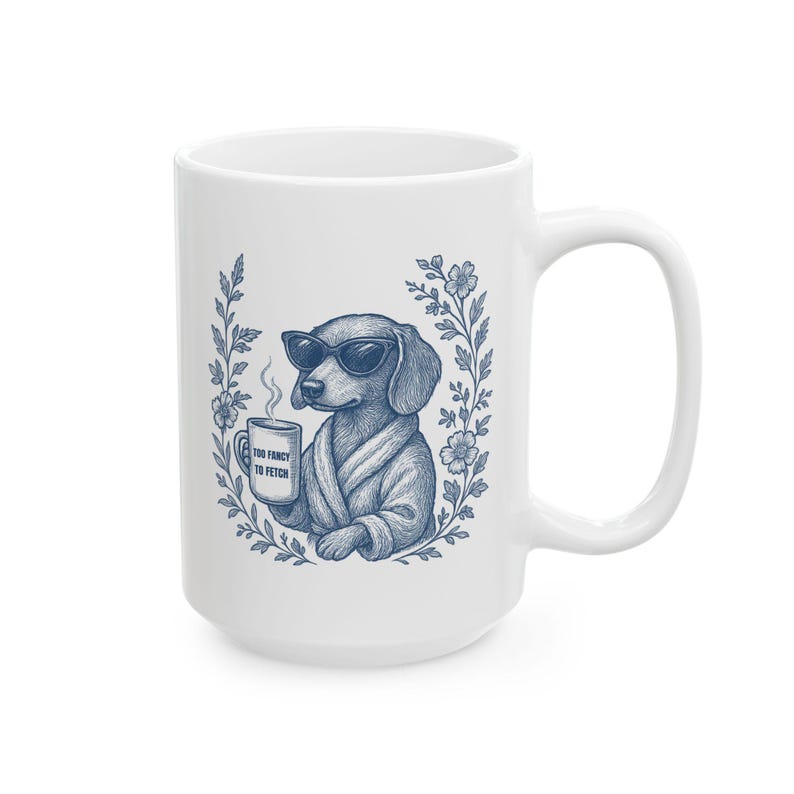 May include: White ceramic mug featuring a dachshund wearing sunglasses and a robe, holding a coffee cup. The mug has the text "Too Fancy to Fetch" and is surrounded by a floral design. A fun gift for dog lovers.