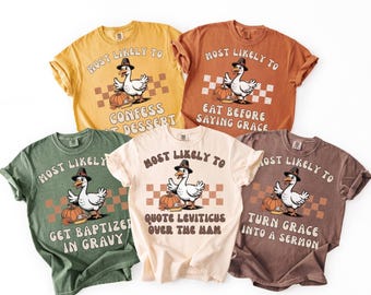 May include: Five different coloured t-shirts, each with a cartoon goose wearing a pilgrim hat and holding a pumpkin. The shirts have the text "Most Likely To" followed by humorous phrases, perfect for autumn.