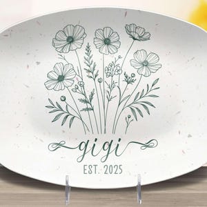 May include: White oval serving platter with a green floral design and the text "gigi est. 2025".