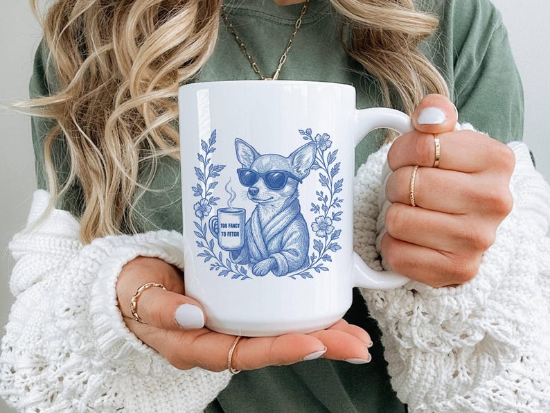 May include: White ceramic mug featuring a blue illustration of a chihuahua wearing sunglasses and a robe, holding a coffee cup. The mug has the text "Too Fancy to Fetch" and is surrounded by floral elements.
