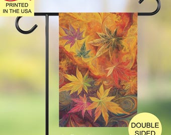 May include: A rectangular garden flag hanging on a black metal stand, featuring a vibrant autumn-themed design with multi-colored maple leaves in shades of red, orange, yellow, and green against a swirling, abstract background of warm fall colors.