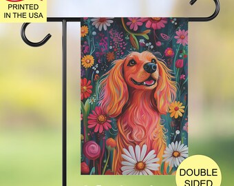May include: A colourful garden flag featuring a stylised illustration of a dog with bright orange and pink fur, surrounded by flowers in shades of pink, purple, yellow, and white. The flag has the text "Joyful Garden Crafts" at the bottom.