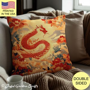 May include: A decorative pillow featuring a red and gold dragon with floral accents. The pillow is double-sided and has a yellow background with a subtle cloud pattern. "Joyful Garden Crafts" is printed in the bottom left corner.