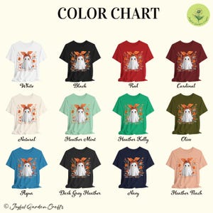 May include: A color chart displays various t-shirts in different colors, each featuring a ghost graphic with floral accents. Colors include white, black, red, cardinal, natural, heather mint, heather kelly, olive, aqua, dark grey heather, navy, and heather peach.