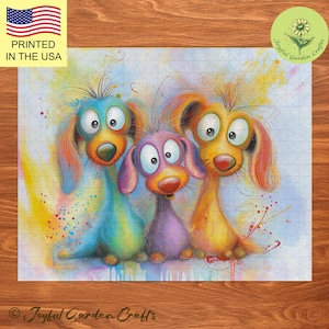 May include: Three cartoon dogs with colorful fur stand side-by-side. The dog on the left is blue and green, the middle dog is purple, and the dog on the right is yellow. The dogs have large eyes and are smiling. The background is a light blue watercolor wash with splashes of color.