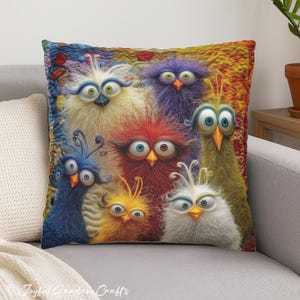 May include: A cushion with a colourful illustration of seven cartoon birds with large eyes and fluffy feathers. The birds are in shades of blue, purple, yellow, red, and green, set against a textured background.
