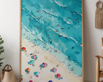 May include: A framed art print depicts a beach scene with turquoise water and white waves. People are scattered along the sandy shore and in the water. Colorful beach umbrellas dot the sand, adding pops of color to the artwork.