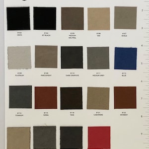 May include: A color chart of 15 suede headliner fabric colors for automotive upholstery. The colors are arranged in rows and columns, with each color labeled with a number and name. The chart is printed on white paper with a black border. The text "Suede Headliner Fabric Colors" is printed at the top of the chart. The text "Dozens of sizes available or 8x10 to custom cut" is printed below the title. The text "SunVisorSolutions.com" is printed at the bottom of the chart.