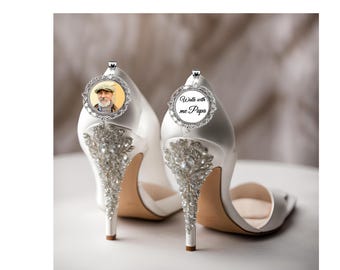 May include: White satin bridal heels with crystal embellishments on the heels. One heel has a photo charm, the other says "Walk with me Papa". Elegant wedding footwear.
