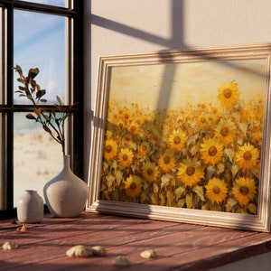 May include: A framed painting of a field of sunflowers in shades of yellow and gold. The sunflowers are in various stages of bloom, with some facing the viewer and others facing away. The background is a soft, hazy yellow.