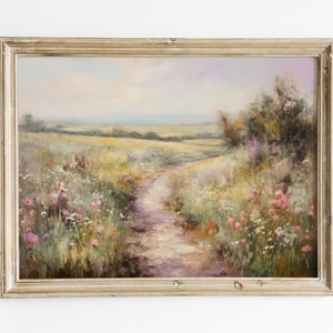 May include: A framed oil painting depicting a winding dirt path through a field of wildflowers. The path leads to a distant horizon with a blue sky and fluffy clouds. The painting is in a light wood frame.