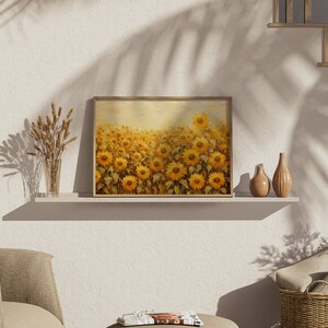 May include: A framed painting of a field of sunflowers in shades of yellow and brown. The painting is on a shelf with a vase of dried wheat and two decorative vases.