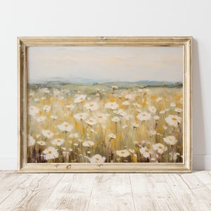 May include: A framed painting of a field of white wildflowers with a blurred background of a distant landscape. The painting is done in a soft, impressionistic style with muted colors.