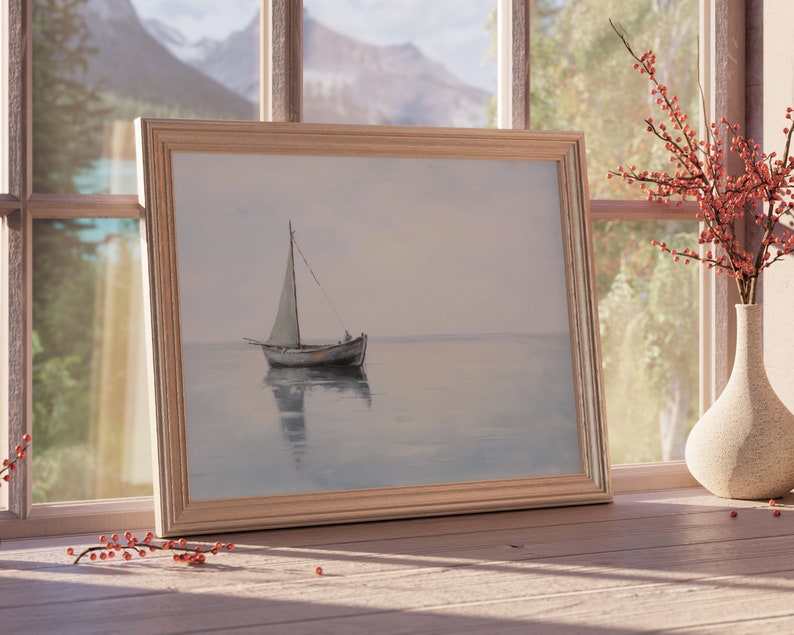 May include: A framed painting depicting a sailboat on a calm body of water. The painting is in a light wood frame and is hanging on a wall.
