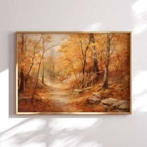 May include: A painting of a forest path in autumn. The trees are mostly bare, but some have yellow leaves. The path is lined with rocks and fallen leaves. The painting is in a wooden frame.