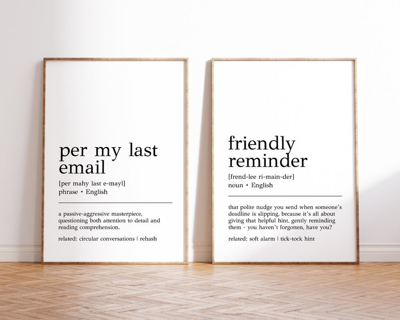 May include: Two black and white printable wall art prints with a minimalist design. The first print defines "per my last email" as a phrase and the second print defines "friendly reminder" as a noun. Both prints include related terms.