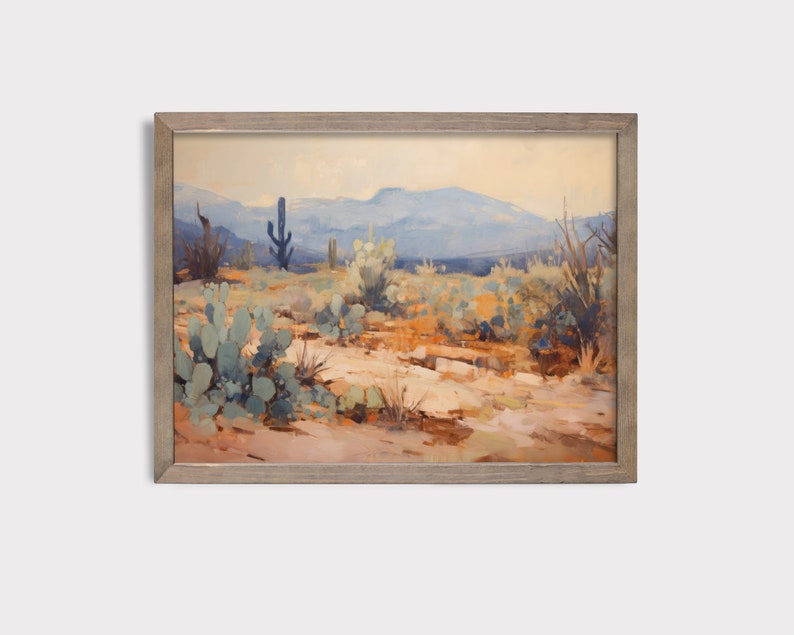 May include: A framed painting depicting a desert landscape with a blue sky, mountains in the distance, and various cacti and desert plants in the foreground.