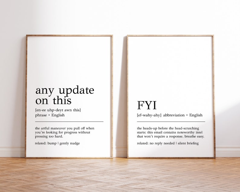 May include: Two framed prints with black text on a white background. The first print defines "any update on this" as a phrase meaning "the artful maneuver you pull off when you're looking for progress without pressing too hard." The second print defines "FYI" as an abbreviation meaning "the heads-up before the head-scratching starts: this email contains noteworthy intel that won't require a response. breathe easy."