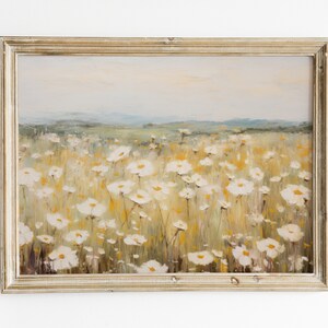 May include: A framed painting of a field of white wildflowers with a hazy background of hills in the distance.