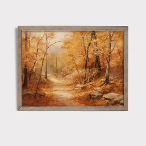 May include: A framed painting of a path through a forest in autumn. The trees are a mix of yellow, orange, and brown, and the path is lined with fallen leaves. The painting is in a rustic wooden frame.